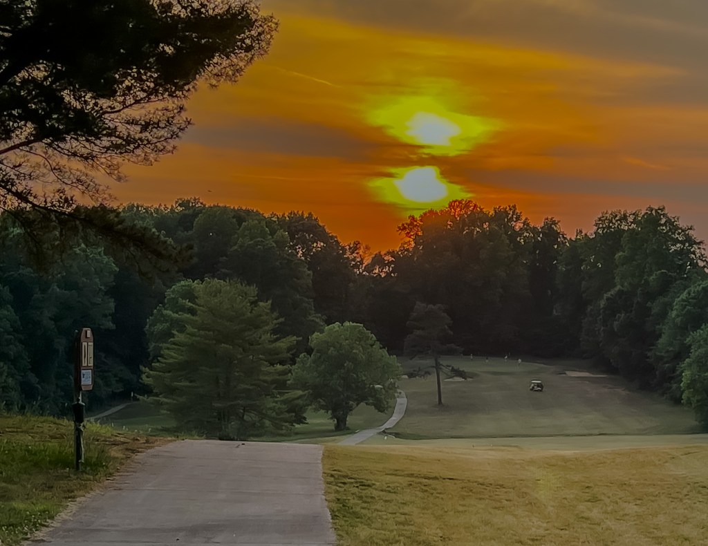 cart path with the sunset in the background